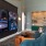 multiple tvs on a wall with seating