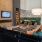 room with seating and a table with a tv